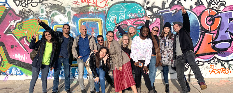 Students in front of the Berlin Wall